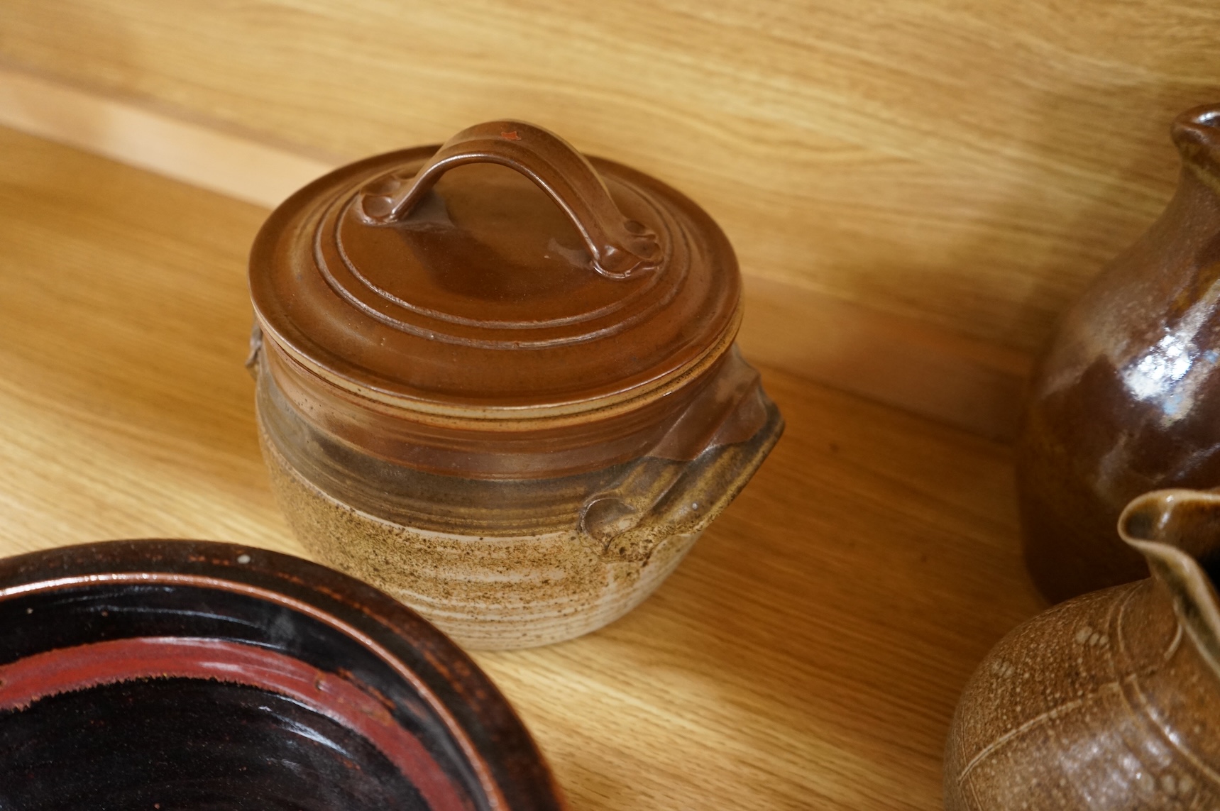 A Poole pottery Aegean dish, together with a selection of Studio pottery bowls, dishes, jugs etc and a Donoghue / Rye cottage model, Poole dish 20cm diameter (14)